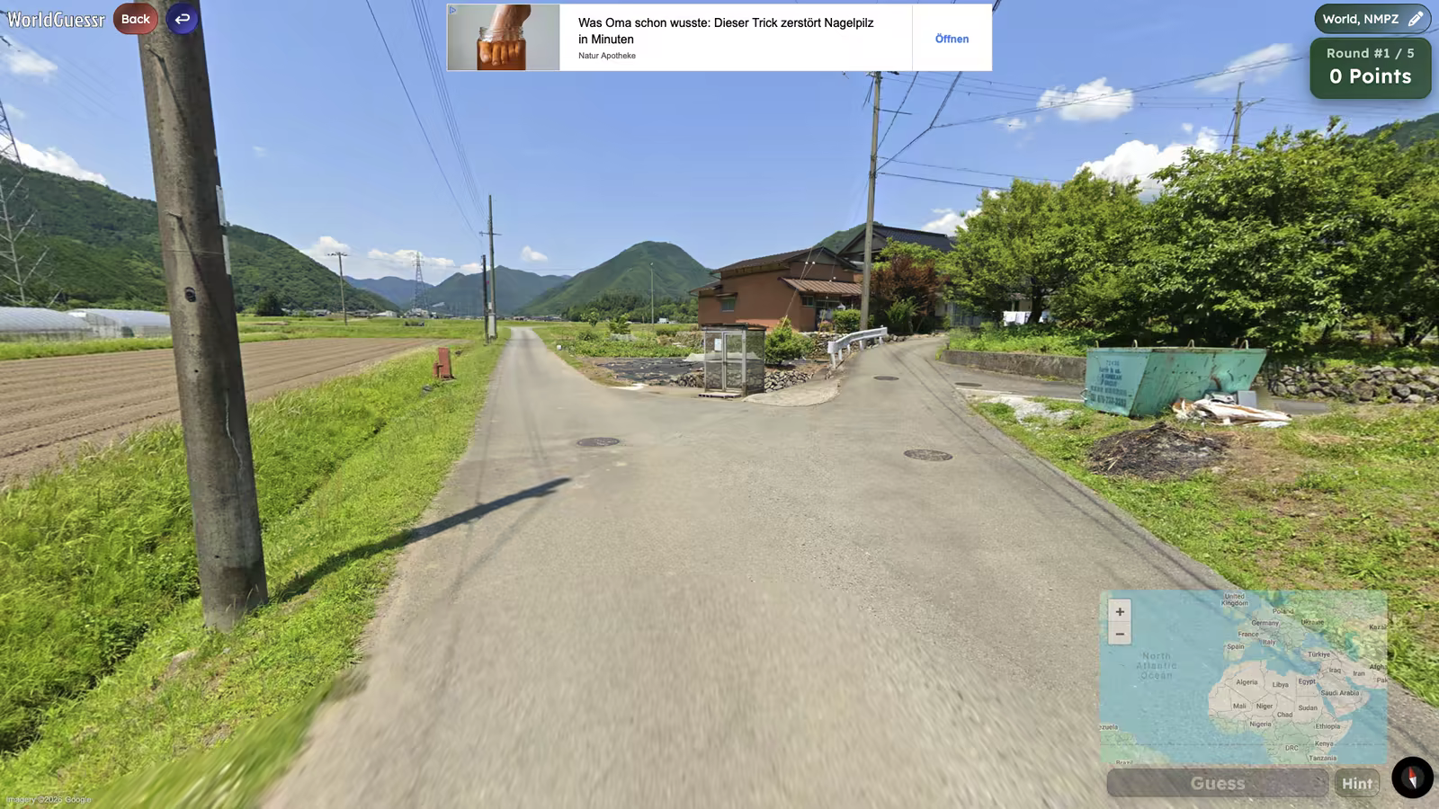 A WorldGuessr NMPZ round on a paved village road